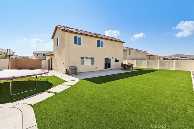 29586 Bisbee Ct, Winchester, CA 92596 - rear view of house featuring a trampoline, a patio, central air condition unit, and stucco siding