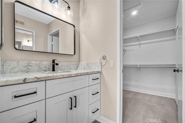 401 Deerfield Ave Unit 84, Irvine, CA 92606 - bathroom featuring a walk in closet, vanity, and baseboards