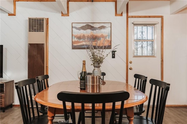 753 Maple Ln, Sugarloaf, CA 92386 - dining space with a heating unit, light wood-style flooring, baseboards, and wooden walls