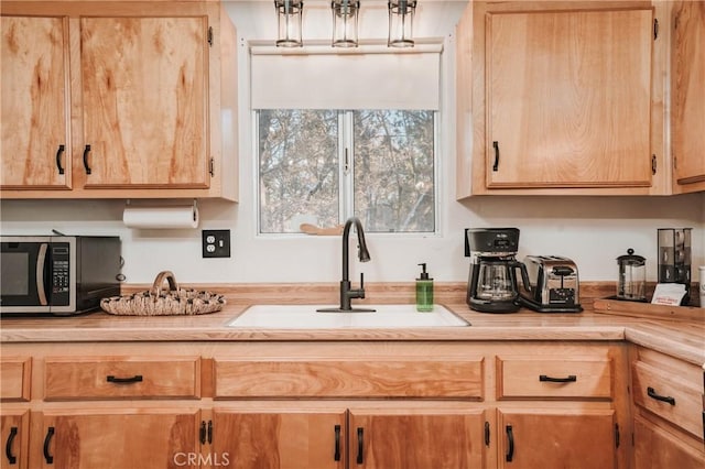 753 Maple Ln, Sugarloaf, CA 92386 - kitchen with a sink, light countertops, and light brown cabinetry