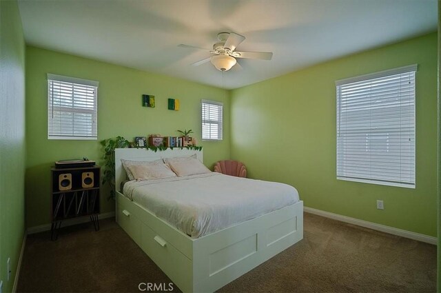 32804 Red Carriage Rd, Winchester, CA 92596 - bedroom featuring multiple windows, dark carpet, baseboards, and a ceiling fan