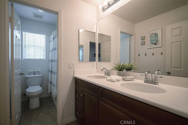32804 Red Carriage Rd, Winchester, CA 92596 - bathroom with toilet, double vanity, tile patterned flooring, and baseboards