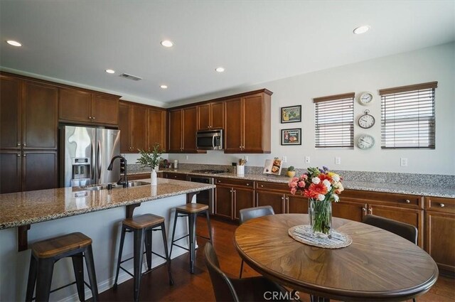 32804 Red Carriage Rd, Winchester, CA 92596 - kitchen featuring stainless steel appliances, a sink, recessed lighting, a breakfast bar area, and light stone counters