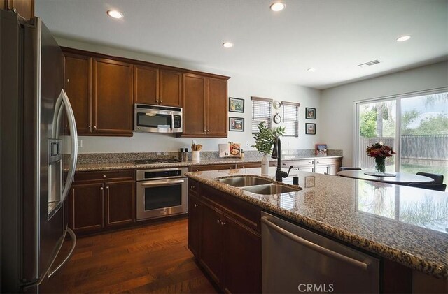 32804 Red Carriage Rd, Winchester, CA 92596 - kitchen with stainless steel appliances, a sink, dark stone counters, recessed lighting, and dark wood-style flooring