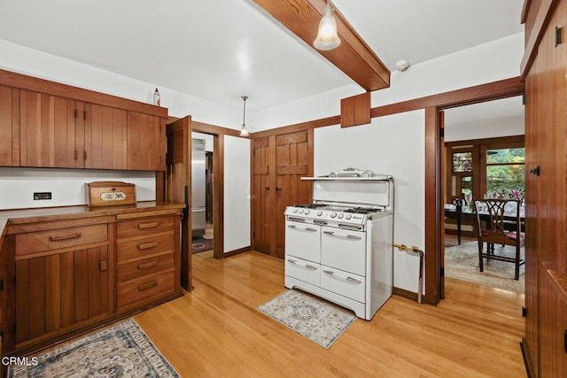 657 Prospect Blvd, Pasadena, CA 91103 - kitchen with double oven range, light wood-style floors, brown cabinetry, beam ceiling, and decorative light fixtures
