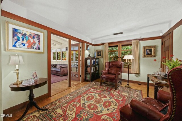 657 Prospect Blvd, Pasadena, CA 91103 - living area featuring light wood-style flooring, baseboards, and a textured ceiling