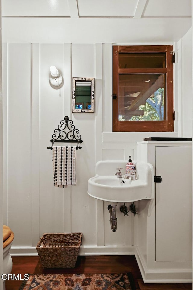 657 Prospect Blvd, Pasadena, CA 91103 - half bathroom featuring wood finished floors, baseboards, and toilet