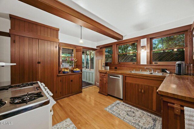 657 Prospect Blvd, Pasadena, CA 91103 - kitchen with stainless steel dishwasher, a sink, light wood-type flooring, plenty of natural light, and wood walls