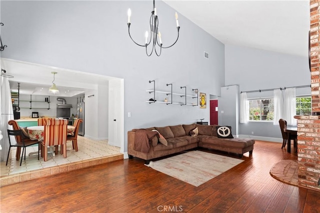 9319 Rowell Ave, Chatsworth, CA 91311 - living room with high vaulted ceiling, wood-type flooring, baseboards, and a chandelier
