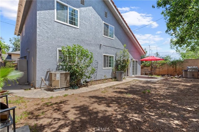 9319 Rowell Ave, Chatsworth, CA 91311 - rear view of property featuring central air condition unit, stucco siding, fence, and a patio