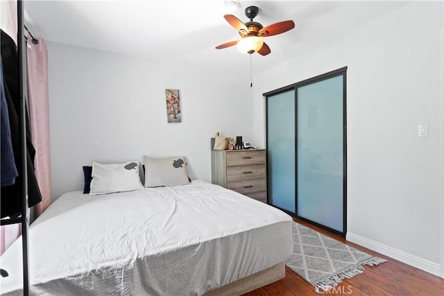 9319 Rowell Ave, Chatsworth, CA 91311 - bedroom with wood finished floors, baseboards, a closet, and a ceiling fan