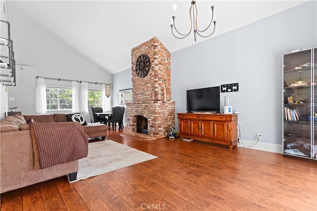 9319 Rowell Ave, Chatsworth, CA 91311 - living room with high vaulted ceiling, wood finished floors, a chandelier, and a fireplace