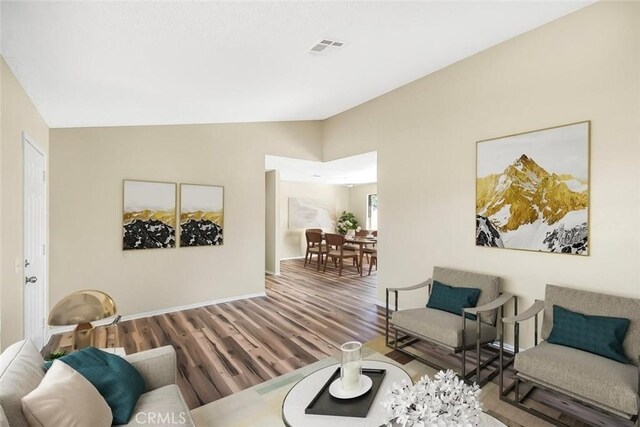 38532 Division St, Palmdale, CA 93550 - living area featuring wood finished floors, lofted ceiling, and baseboards