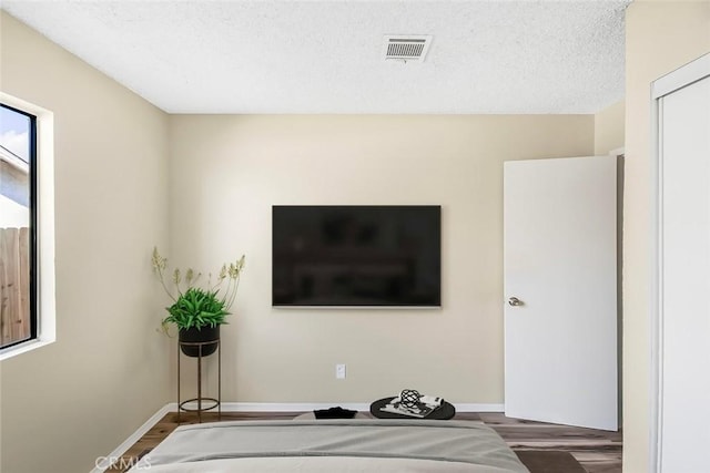 38532 Division St, Palmdale, CA 93550 - bedroom featuring wood finished floors, baseboards, and a textured ceiling