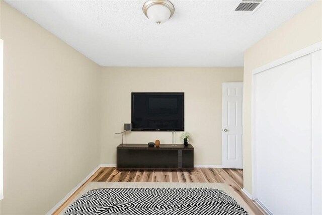 38532 Division St, Palmdale, CA 93550 - bedroom with wood finished floors, baseboards, a closet, and a textured ceiling