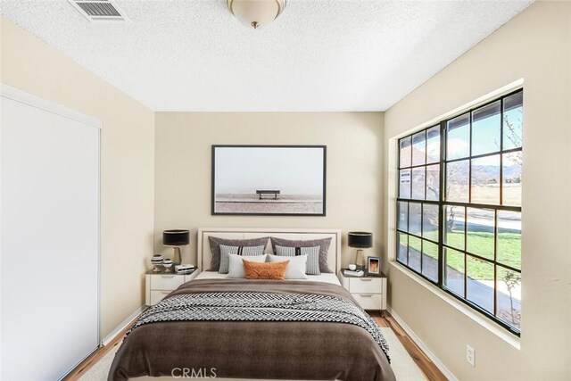 38532 Division St, Palmdale, CA 93550 - bedroom with a textured ceiling, wood finished floors, and baseboards