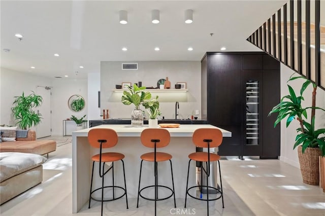 700 Main St Unit 4, Venice, CA 90291 - kitchen with open floor plan, light countertops, a sink, a breakfast bar area, and recessed lighting