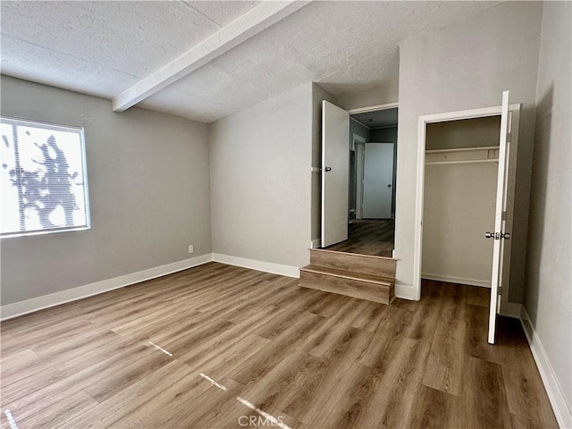 1516 W Burnett St, Long Beach, CA 90810 - unfurnished bedroom with wood finished floors, a textured ceiling, a closet, and baseboards