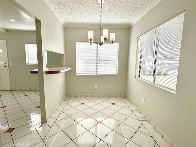 1516 W Burnett St, Long Beach, CA 90810 - unfurnished dining area featuring plenty of natural light, a chandelier, light tile patterned floors, a textured ceiling, and baseboards