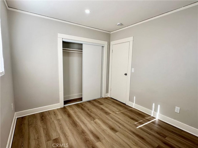 1516 W Burnett St, Long Beach, CA 90810 - unfurnished bedroom featuring crown molding, wood finished floors, a closet, baseboards, and recessed lighting