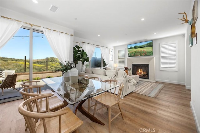 214 Canterbury, Irvine, CA 92618 - dining space featuring a lit fireplace, baseboards, light wood finished floors, and recessed lighting