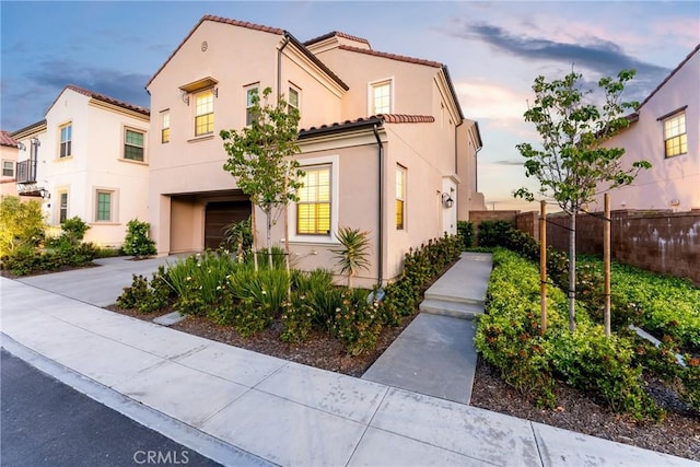 214 Canterbury, Irvine, CA 92618 - view of front of house featuring fence, an attached garage, stucco siding, and a tile roof
