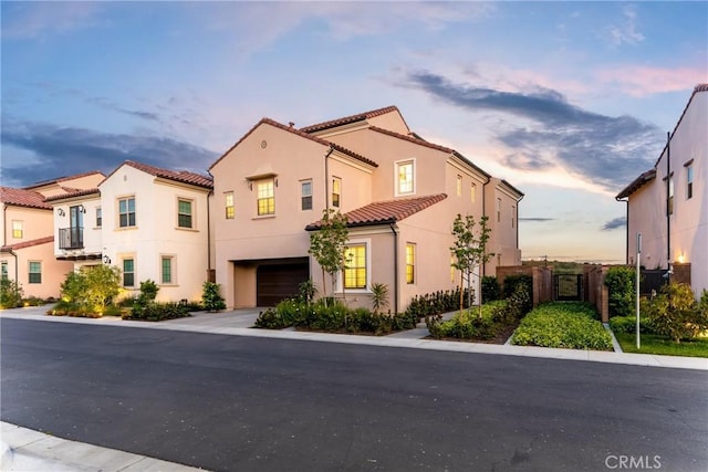 214 Canterbury, Irvine, CA 92618 - view of front of home with a tile roof, a garage, stucco siding, and fence