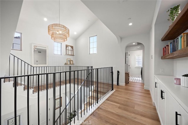 214 Canterbury, Irvine, CA 92618 - hall featuring light wood-style flooring, arched walkways, a chandelier, recessed lighting, and baseboards
