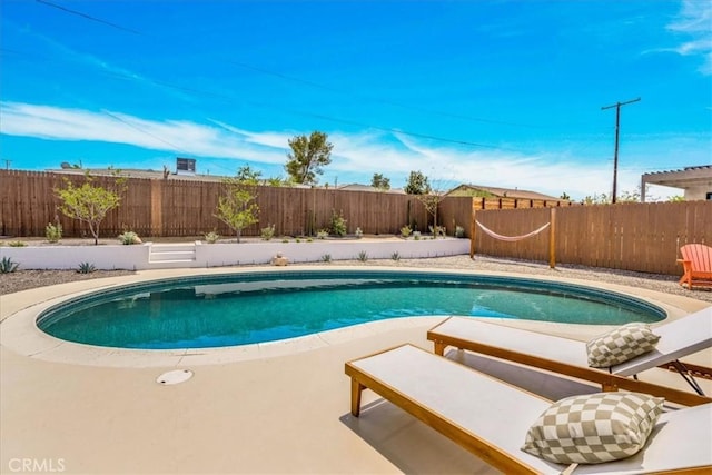 view of swimming pool featuring a fenced backyard