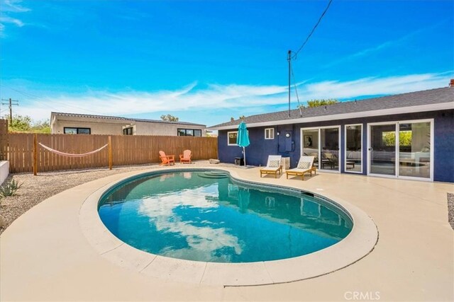 view of pool with a fenced backyard and a patio area