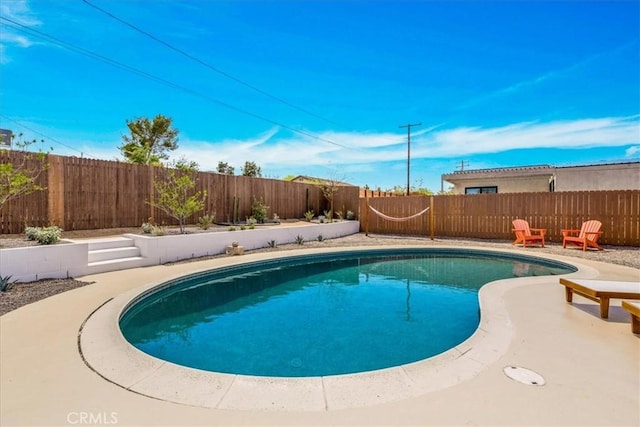 view of swimming pool featuring a fenced backyard