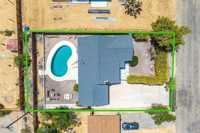 aerial view of property and surrounding area featuring a pool and property boundaries highlighted