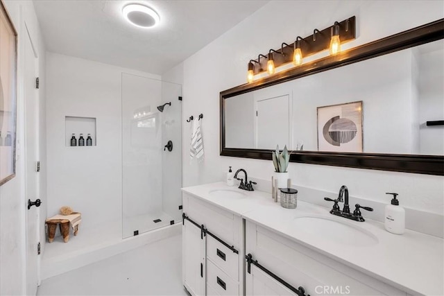 bathroom with a stall shower and double vanity