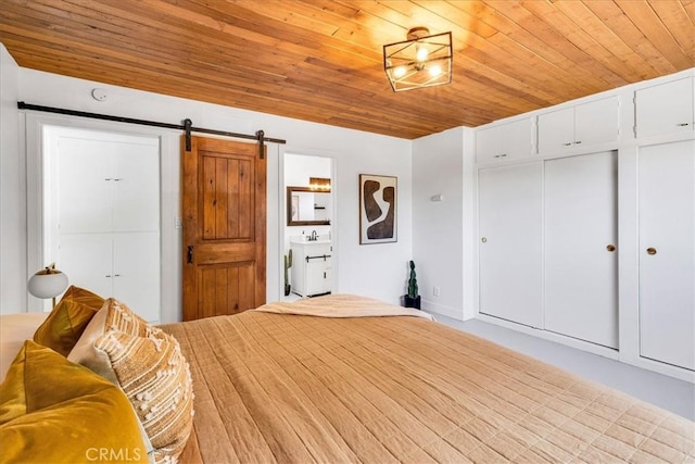 bedroom featuring a barn door and wood ceiling