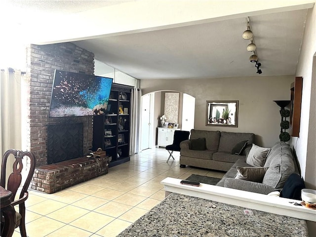 903 Lacon Ave, La Puente, CA 91744 - living area featuring light tile patterned floors, arched walkways, and rail lighting