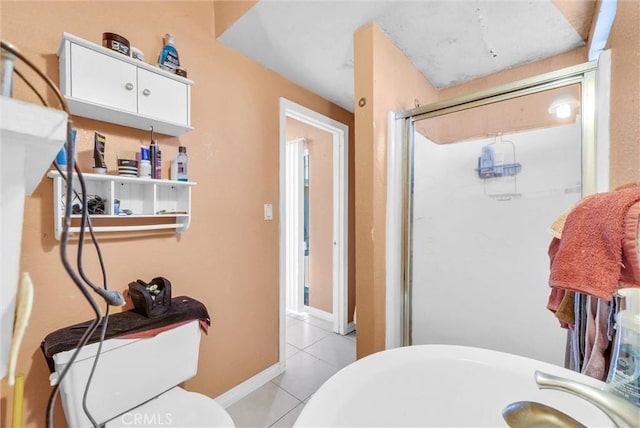 full bathroom featuring tile patterned floors and a shower stall