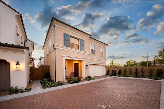 109 Fairgreen, Irvine, CA 92618 - view of front of property featuring decorative driveway, stucco siding, a garage, and a gate