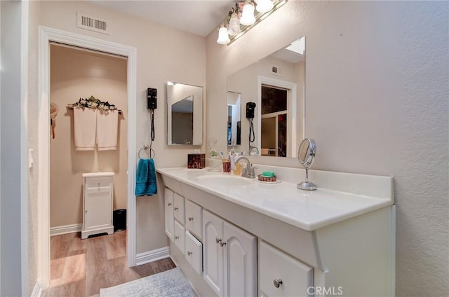 8646 Butte Cir Unit 604B, Huntington Beach, CA 92646 - bathroom with wood finished floors, vanity, and baseboards