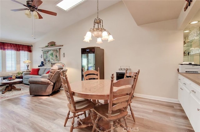 8646 Butte Cir Unit 604B, Huntington Beach, CA 92646 - dining room with light wood-style floors, ceiling fan, high vaulted ceiling, a chandelier, and baseboards