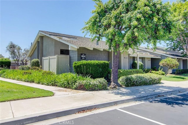 8646 Butte Cir Unit 604B, Huntington Beach, CA 92646 - ranch-style house with roof with shingles and uncovered parking