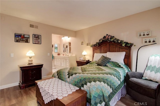 8646 Butte Cir Unit 604B, Huntington Beach, CA 92646 - bedroom with wood finished floors, baseboards, ensuite bath, and a sink