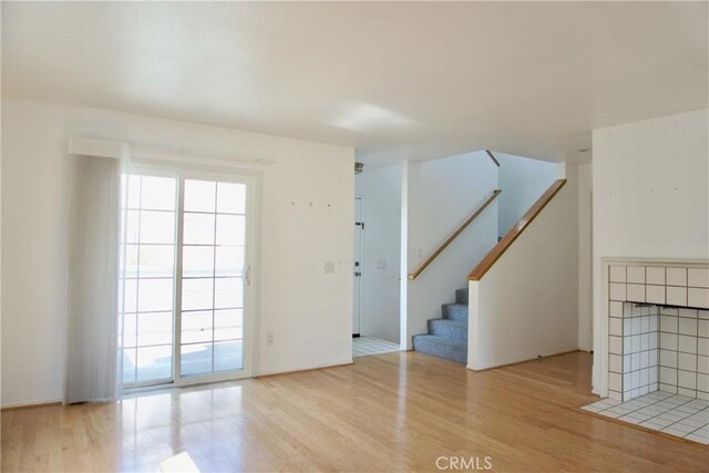2800 Plaza Del Amo 190, Torrance, CA 90503 - unfurnished living room with wood finished floors, stairway, and a tile fireplace