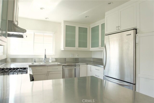 2800 Plaza Del Amo 190, Torrance, CA 90503 - kitchen with stainless steel countertops, stainless steel appliances, a sink, white cabinets, and glass insert cabinets