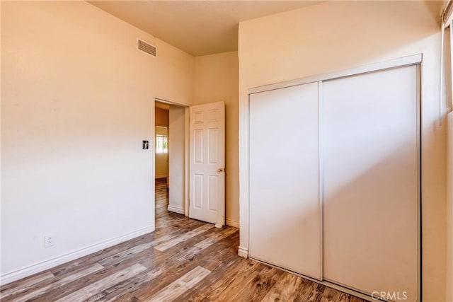 25189 Gentian Ave, Moreno Valley, CA 92551 - unfurnished bedroom featuring wood finished floors, a closet, and baseboards