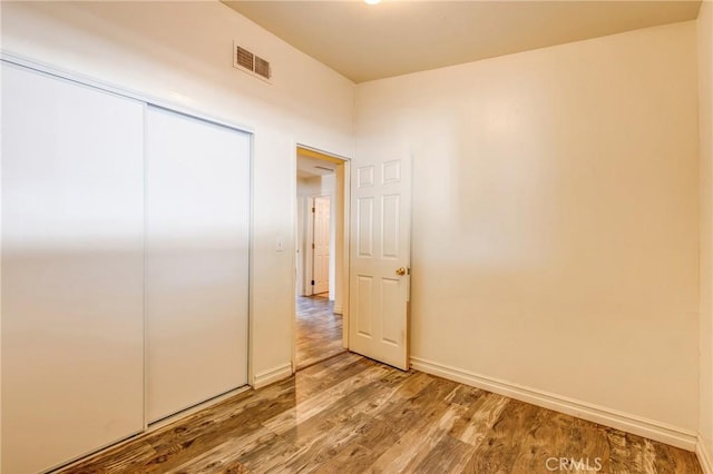 25189 Gentian Ave, Moreno Valley, CA 92551 - unfurnished bedroom with wood finished floors, baseboards, and a closet
