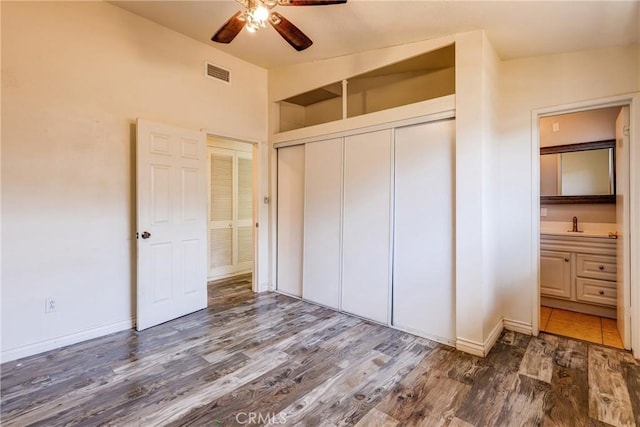 25189 Gentian Ave, Moreno Valley, CA 92551 - unfurnished bedroom featuring wood finished floors, a closet, baseboards, and a sink