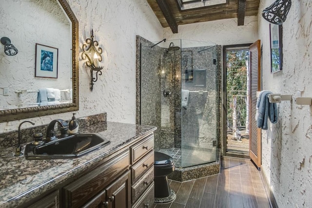 15390 Las Planideras, Rancho Santa Fe, CA 92067 - bathroom featuring a textured wall, a stall shower, toilet, vanity, and wood finished floors