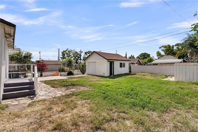 970 E 6th St, Pomona, CA 91766 - view of yard featuring a garage, an outdoor structure, and driveway