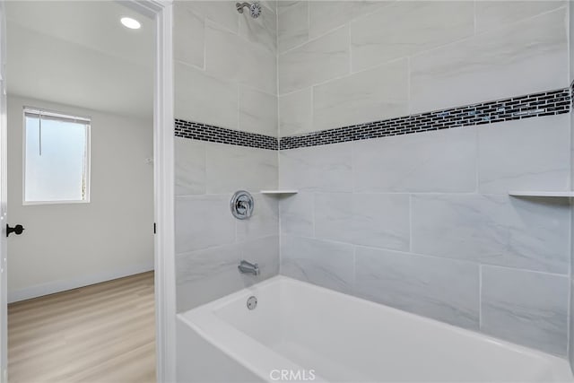 970 E 6th St, Pomona, CA 91766 - bathroom with wood finished floors, shower / bathtub combination, and baseboards