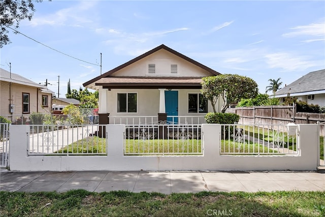 970 E 6th St, Pomona, CA 91766 - view of front of property with covered porch, stucco siding, and a fenced front yard